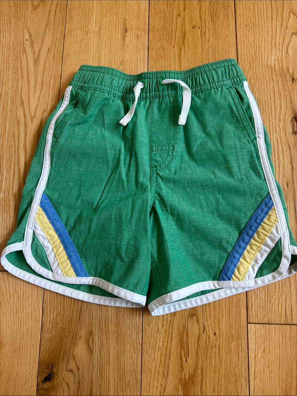 Hanna Andersson green swim trunks with blue and yellow accents Sz 4y